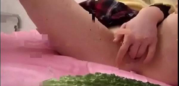  Asian playing with cucumber
